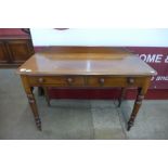 A Victorian mahogany two drawer writing table