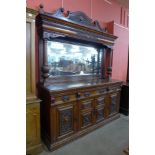 An Art Nouveau carved walnut mirrorback sideboard