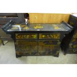 A Chinese black lacquered chinoiserie side cabinet