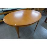 A teak extending dining table