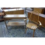 An Ercol style beech elbow chair and a teak metamorphic trolley