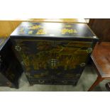 A Chinese black lacquered chinoiserie side cabinet