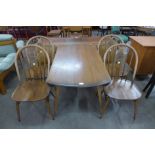 An Ercol Golden Dawn elm and beech Windsor drop leaf table and four chairs