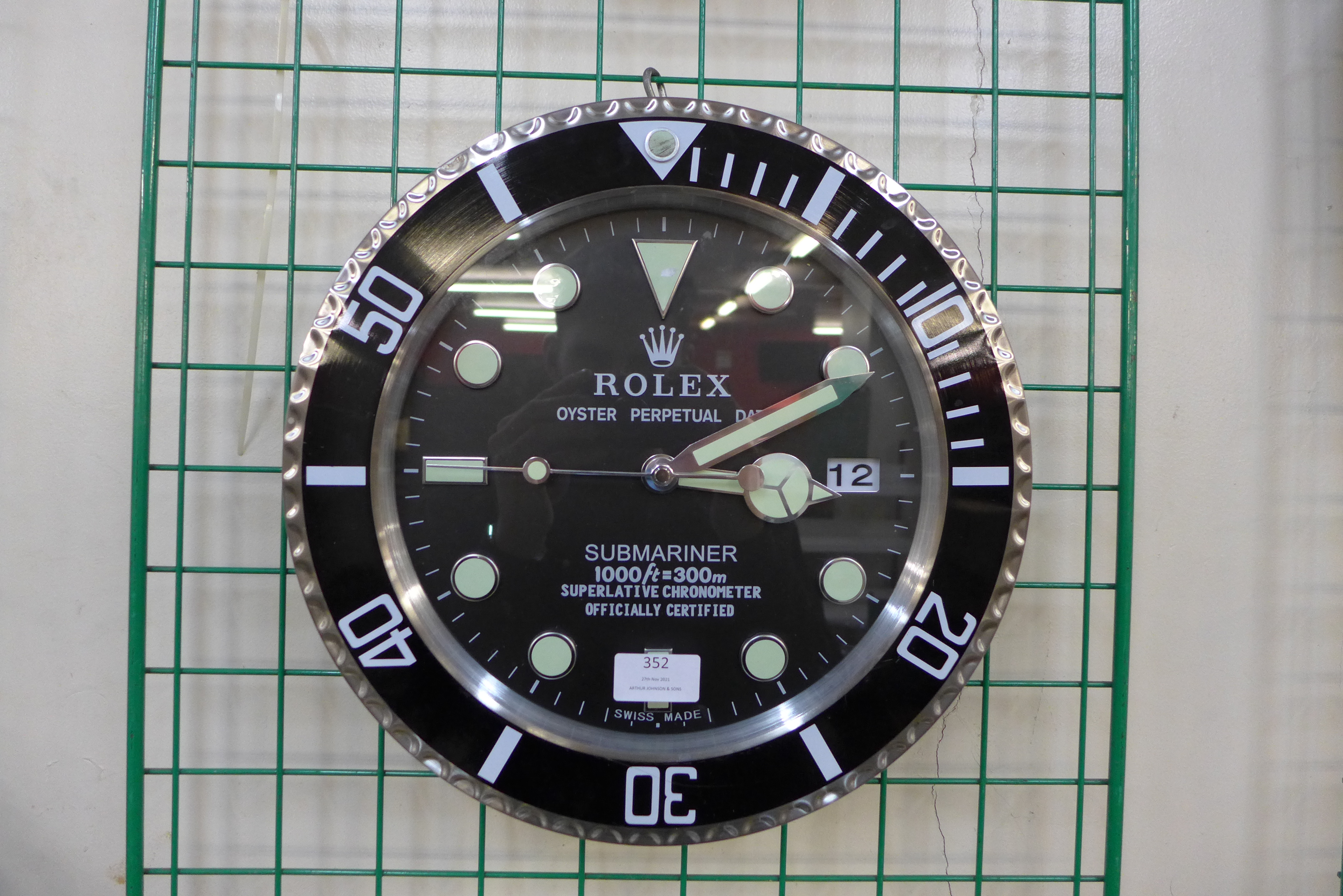 A Rolex style dealer's circular wall clock