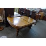 A Victorian oak extending dining table