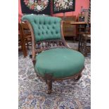 A Victorian walnut and green fabric upholstered lady's chair