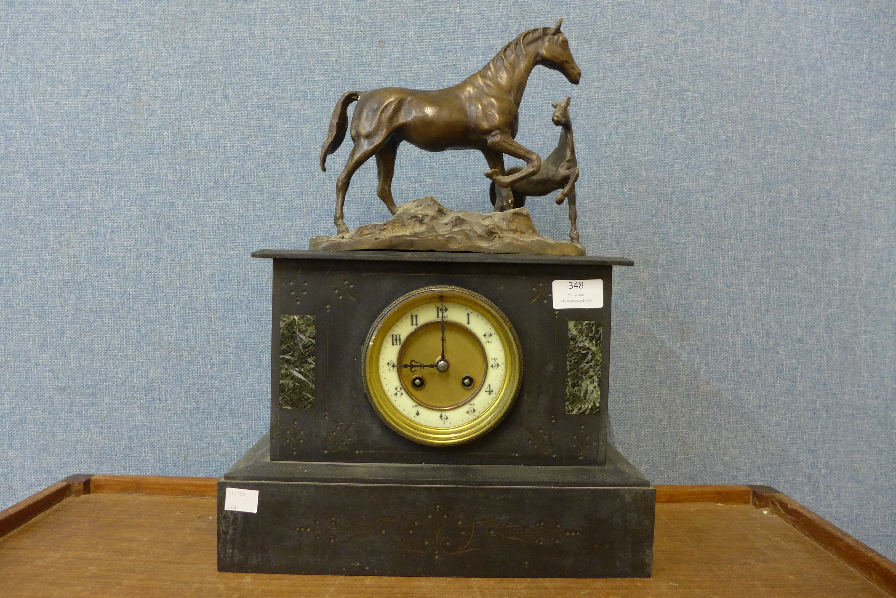 A 19th Century French Belge noir mantel clock, surmounted with bronze figure of horse and foal