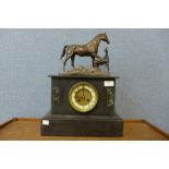 A 19th Century French Belge noir mantel clock, surmounted with bronze figure of horse and foal