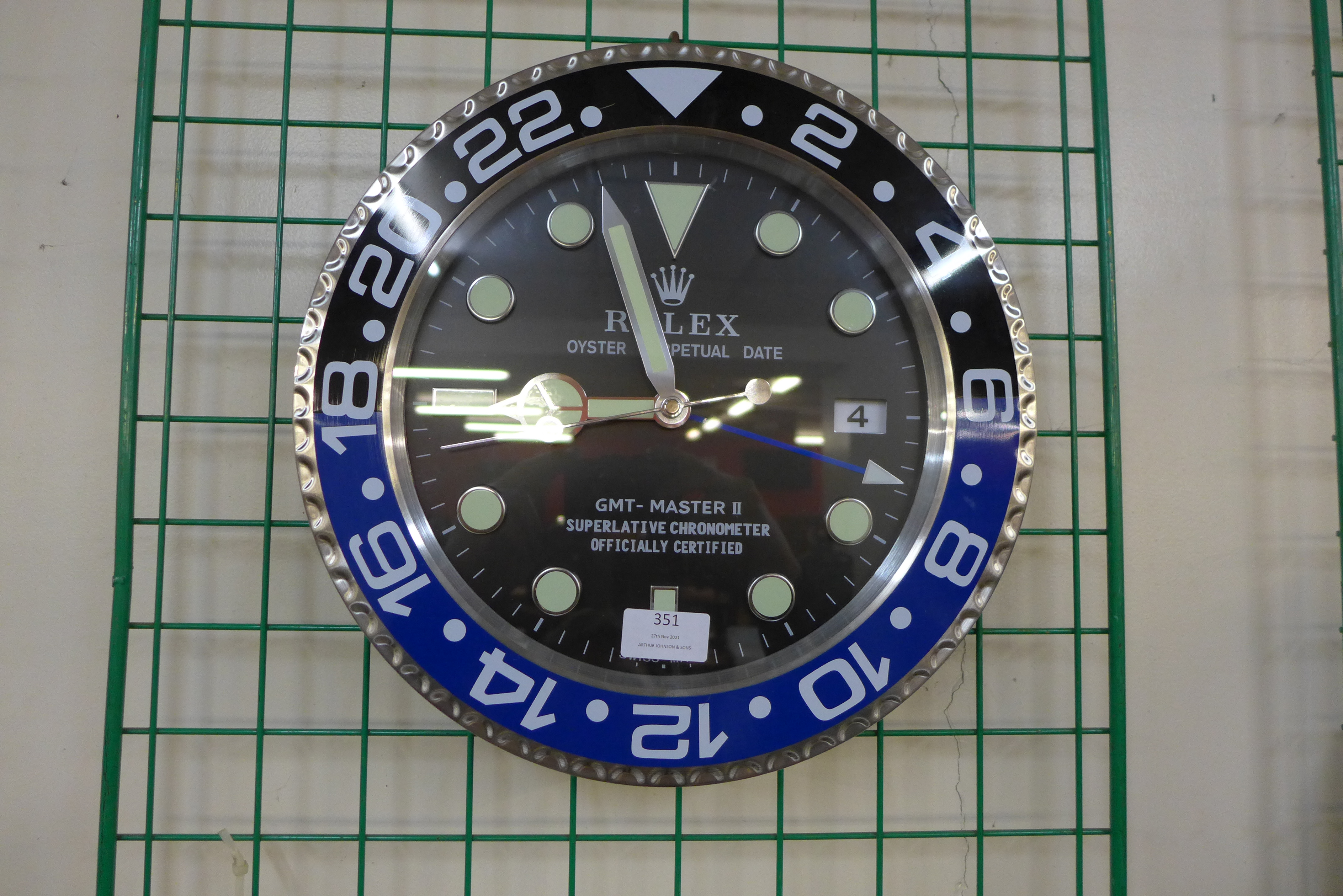 A Rolex style dealer's circular wall clock