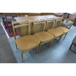 A set of four light elm dining chairs