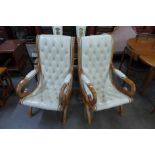 A pair of Regency style mahogany and leather upholstered open armchairs
