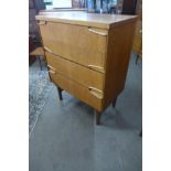 A teak chest of drawers