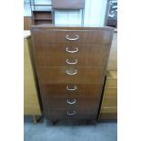 A teak chest of drawers