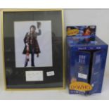A Dr. Who framed photograph with Tom Baker signature and boxed Dr. Who Tardis Police Box with Tom