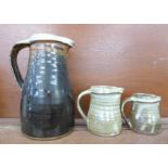 Three Bernard Leach pottery jugs, all three with small chips on the spouts, tallest 23.5cm