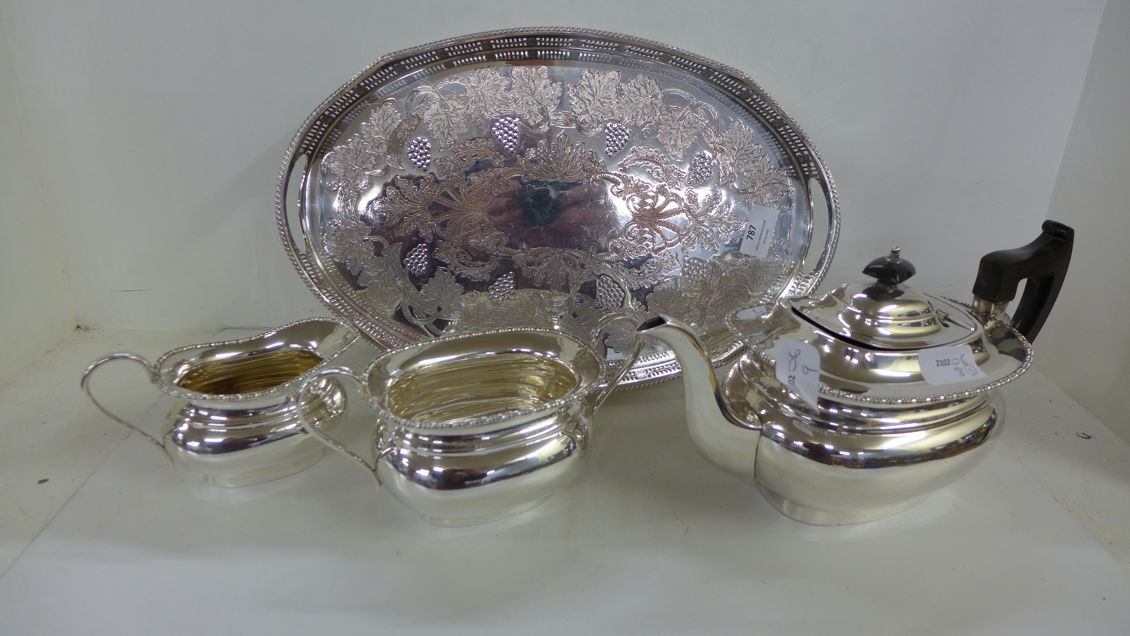 An EPS on copper tray, by Viners of Sheffield and a three piece plated tea service