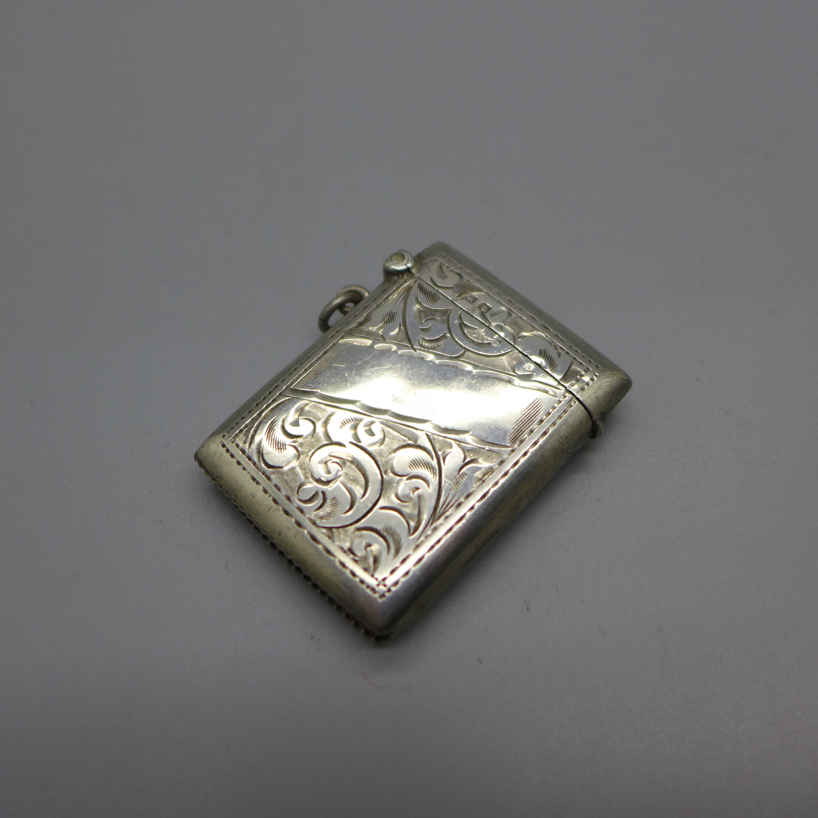 A silver vesta case