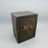 A novelty tin-plate money box in the form of a safe