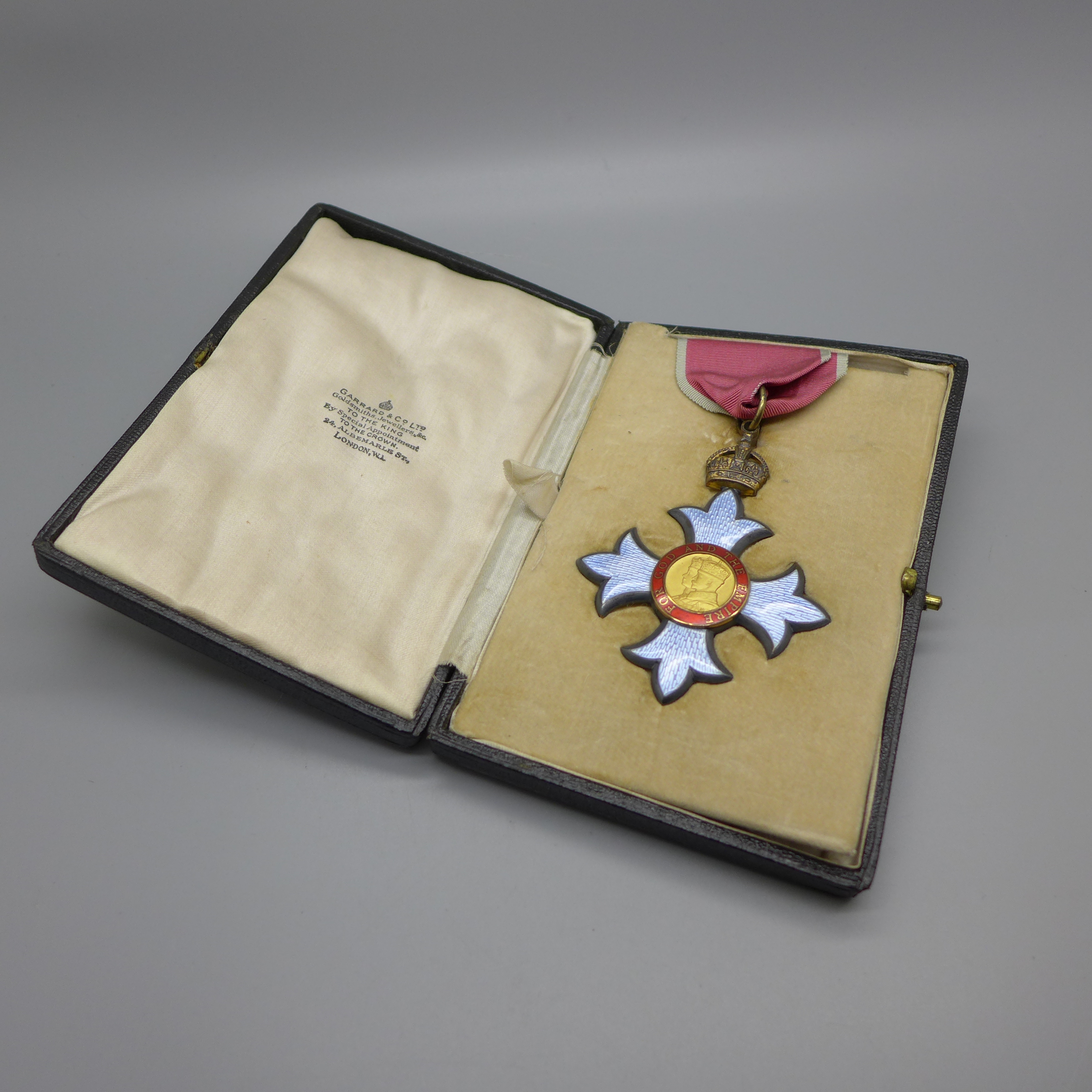 A King George V C.B.E. medal, in a fitted Garrard case