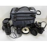 A Canon A-1 35mm SLR camera with 50mm & 70-150mm FD lenses & bag