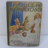 A hardback Alice in Wonderland book by Lewis Carroll, with 24 full size colour plates by Margaret W.