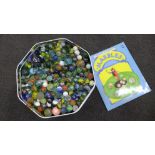 A large tin of old marbles and marbles games book