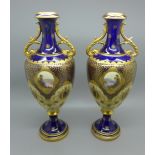 A pair of Coalport blue and gilt decorated vases, lacking lids, restored