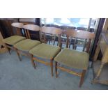 A set of four teak dining chairs