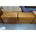 A pair of teak two door side cabinets