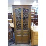 An Old Charm carved oak freestanding corner cabinet