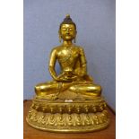 An oriental bronze figure of a seated deity