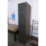 A large seven drawer military green filing cabinet