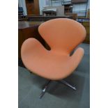 An Arne Jacobsen style chrome and upholstered swan chair