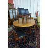 A teak extending dining table and six chairs