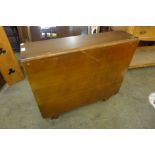 A teak drop leaf table