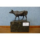 A small French style bronze figure of a cow, on black marble socle,15cms h