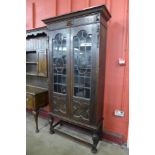 An early 20th Century Jacobean Revival oak two door bookcase