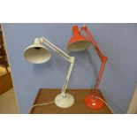 Two red and cream metal anglepoise desk lamps