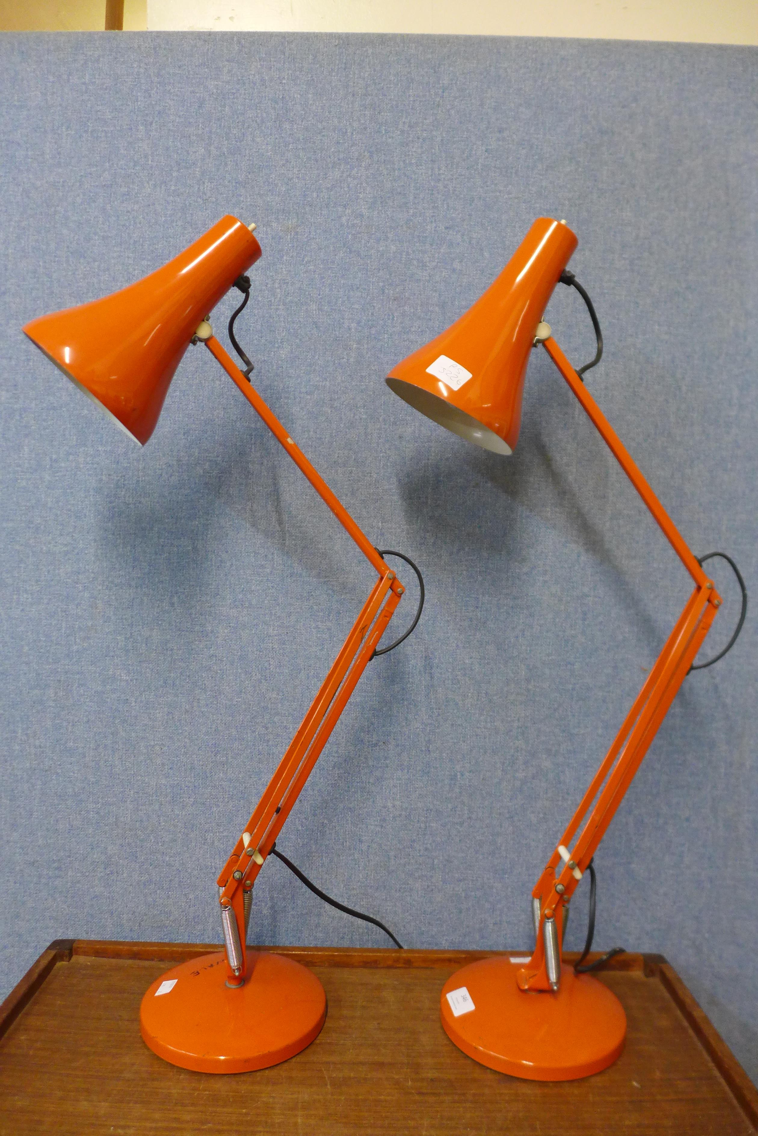 A pair of vintage orange metal anglepoise desk lamps