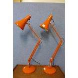 A pair of vintage orange metal anglepoise desk lamps