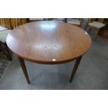 A teak circular dining table