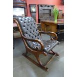 A mahogany and brown buttoned leather rocking chair