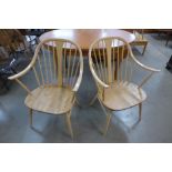 A pair of Ercol Blonde elm and beech 514 model Windsor cowhorn armchairs