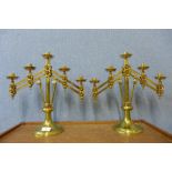 A pair of Victorian Gothic brass ecclesiastical adjustable candelabra