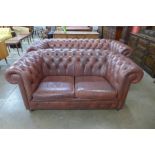 A burgundy leather Chesterfield settee