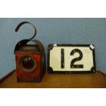 A railway lamp and a cast iron 12 plaque