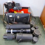 A leather camera bag containing a Praktica Super TL 35mm film camera and equipment including