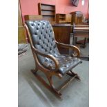A mahogany and brown buttoned leather rocking chair