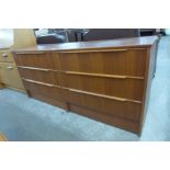 A teak chest of drawers