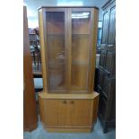 A teak corner cabinet and a Formica topped coffee table